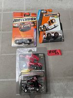 All three sealed die-cast vehicles on blister cards