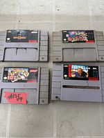 All four SNES cartridges laid out showing front labels