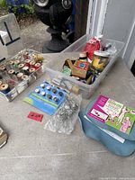overview of all sewing items on table including spools, notions bin, snap pack, iron-on packet, safety pins, pin dish