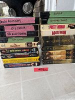 Front view of two stacks of labelled VHS videocassettes showing all visible titles