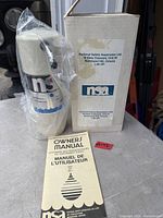 Sealed NSA water treatment unit with manual and original box visible