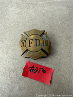 Front view of brass FD Maltese cross belt buckle
