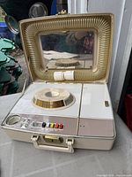 Closed case opened showing mirror, hose, control panel