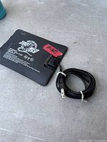 Front view of Zoo Med heating pad and coiled power cord
