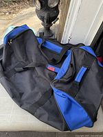 Overall view of black and blue rolling duffle bag