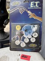 Front of sealed E.T. ReelCoinz package showing five medallions