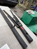 Overall view of two steel extensions and clamp bracket