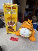Game box and Garfield massager on tabletop