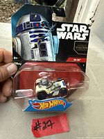Front view of sealed Hot Wheels Star Wars R2-D2 character car on card