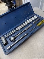 Open case showing ratchet, sockets, extensions, driver handle