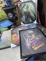 Five framed lenticular prints on table, front print shows skeleton “Sweet Dreams,” rear print shows Ghostface