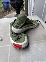 View of both sneakers showing uppers and soles, color and wear