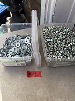 Two plastic boxes, left with washers, right with nuts