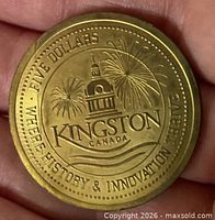 Obverse showing Kingston City Hall, fireworks, denomination and motto
