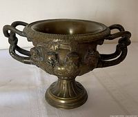 front view showing handles, relief work, pedestal