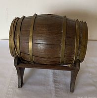 Side view of miniature oak barrel on cradle stand