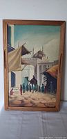 Full view of framed oil painting depicting Cairo market scene