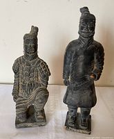 Front view of both terracotta warrior replicas displaying poses and overall condition