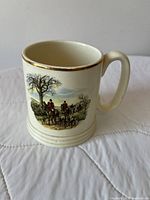Mug front showing main hunting scene, gold rim, ribbed base