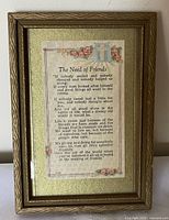 Front view of framed lithograph showing poem text and decorative border