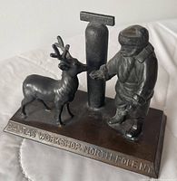 Front view showing Santa, reindeer, North Pole post, and embossed base text