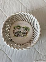 Top view of reticulated porcelain bowl showing painted Badacsony scene