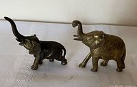 Front view of both brass elephant figurines