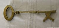 Full view of brass skeleton key, obverse side