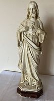Full front view of chalkware Sacred Heart Jesus statue on faux wood base