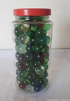 jar filled with assorted marbles, front view