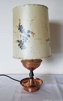 Lamp assembled showing copper base and parchment shade with pressed leaves
