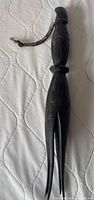 Full view front of carved cannibal fork showing tines and handle