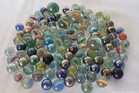 Pile of assorted glass marbles showing variety of colors and sizes