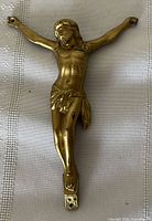 Front view of gilded Jesus corpus showing detail and gold finish