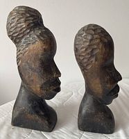 Front and side profile of both ironwood busts