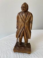 Front view of carved wooden old man figure