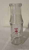 Front view showing red Rosebay Dairy Napanee imprint and ribbed design