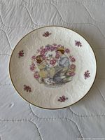 Front view of plate showing embossed rim, gold edge and central courting couple illustration