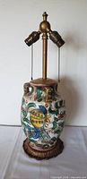 Full view of lamp showing ceramic body, dual socket fixture, metal base