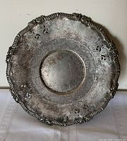 Front view of ornate silver-plated tray