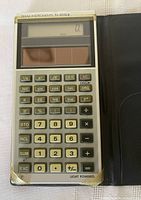 Open calculator in wallet showing keypad, solar panel, LCD