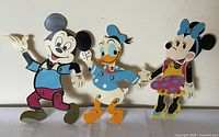 Front view of all three articulated plastic Disney figures