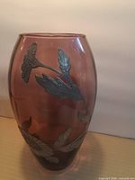 Full view of amethyst glass vase showing overall shape and pewter overlay