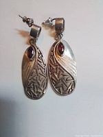 Both earrings front view showing design, gemstones, texture