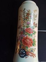 Full view of vase showing floral cart motif and crackle glaze
