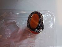 Top view of ring showing carnelian cabochon and ornate filigree basket