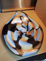 Top view showing overall shape, swirl pattern, mounting hole