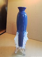 Full view of cobalt blue vase with fins and root base