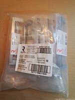 Sealed contractor bag containing 10 individually wrapped pulls with Richelieu label visible