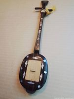 Full view of Shudraga lute showing overall design, inlay, tassel